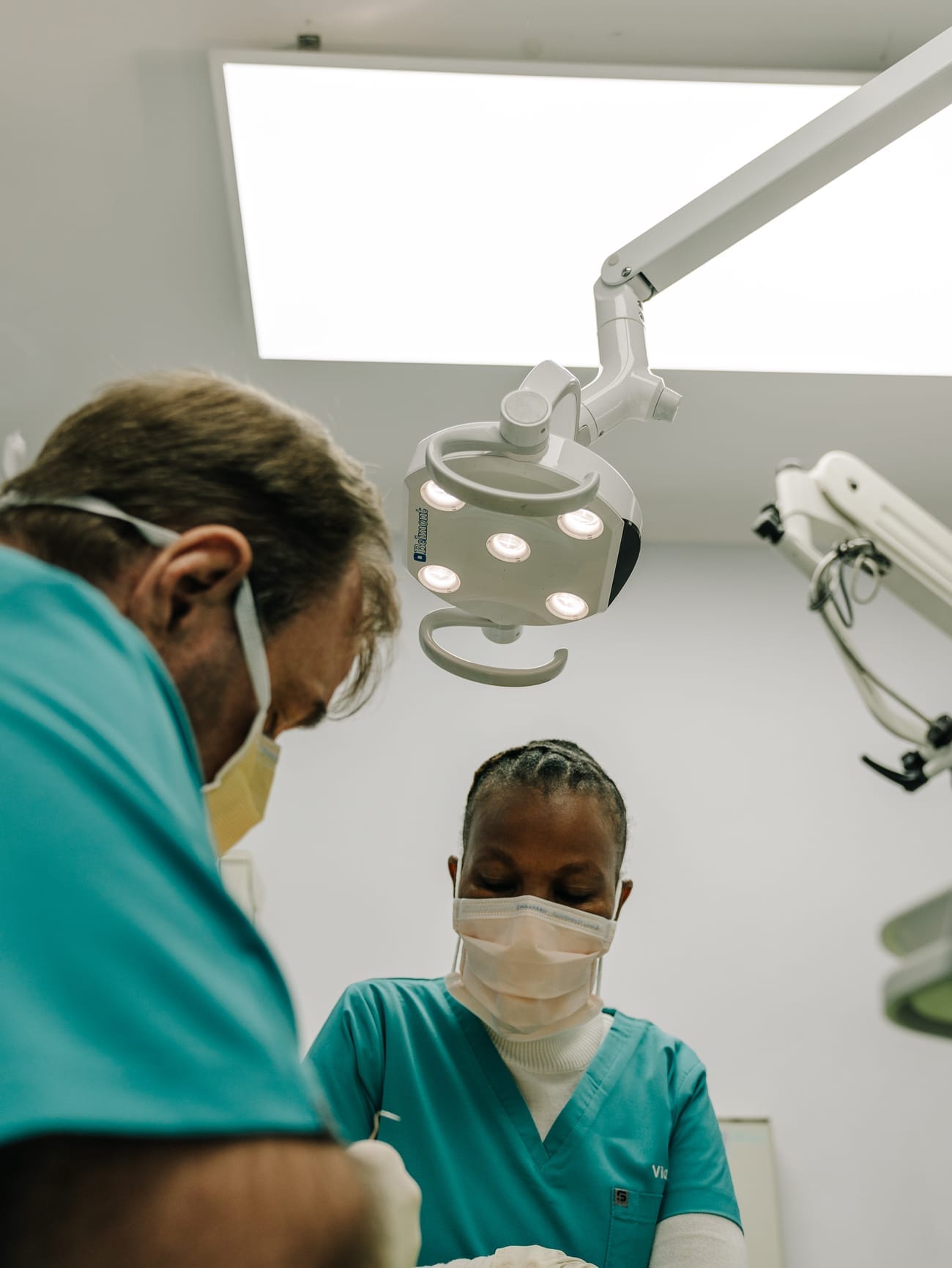 Dr Eugene Kleynhans and a dental assistant treating a patient at Smile Connection Dental Studio