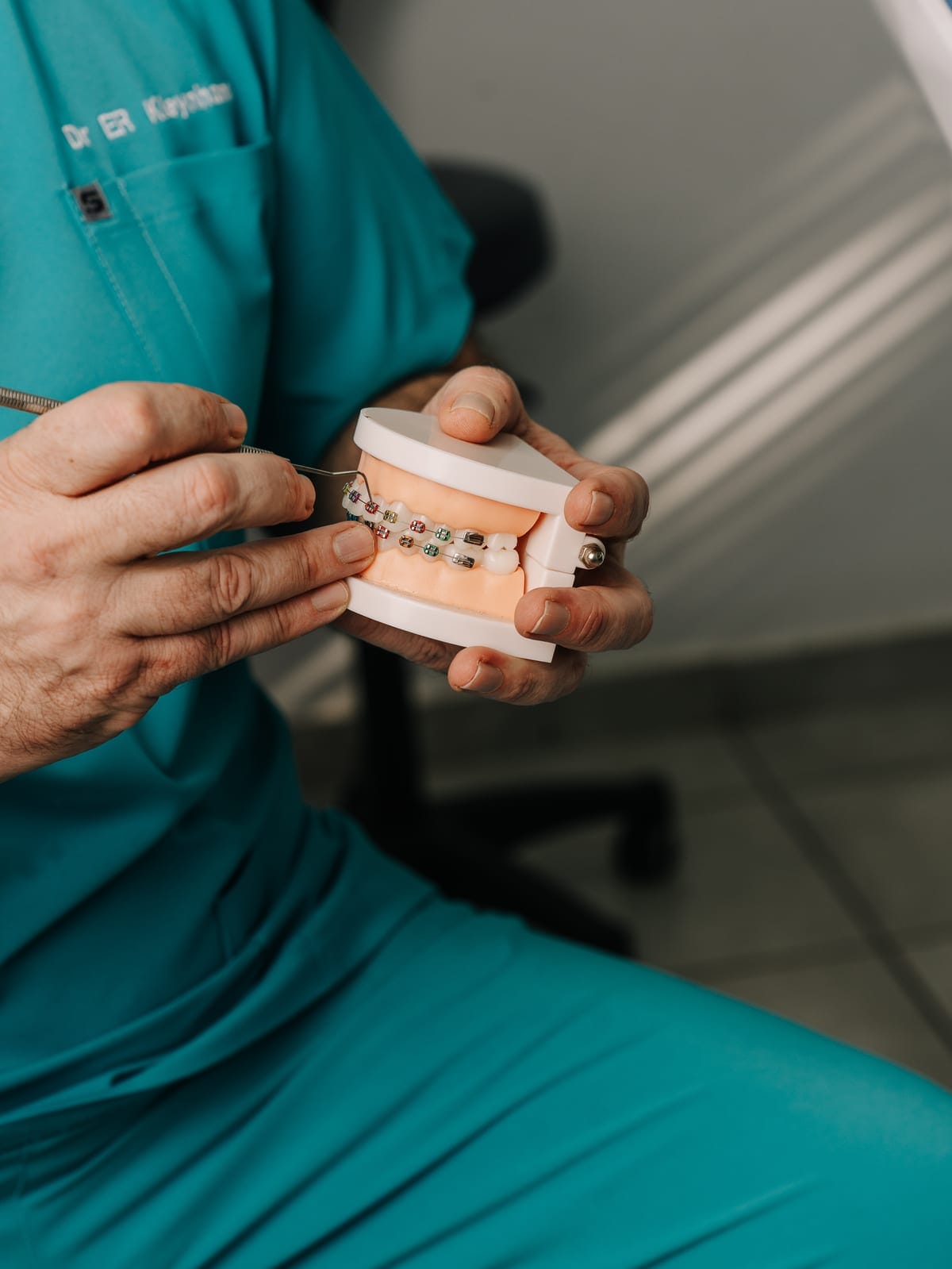 A Smile Connection team member holding a dental model in Newlands, Pretoria