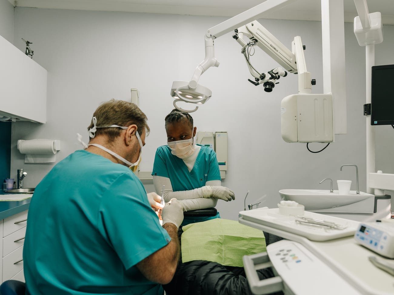 Dr Eugene Kleynhans and a dental assistant treating a patient in the surgery at Smile Connection Dental Studio, Pretoria